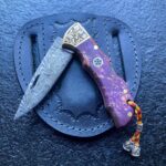 Damascus Folding Pocket Knife – Purple Resin Handle with Engraved Bolster & Leather Sheath