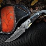 Handmade Damascus Folding Pocket Knife – Black Horn Handle with Brass Bolster & Tooled Leather Sheath