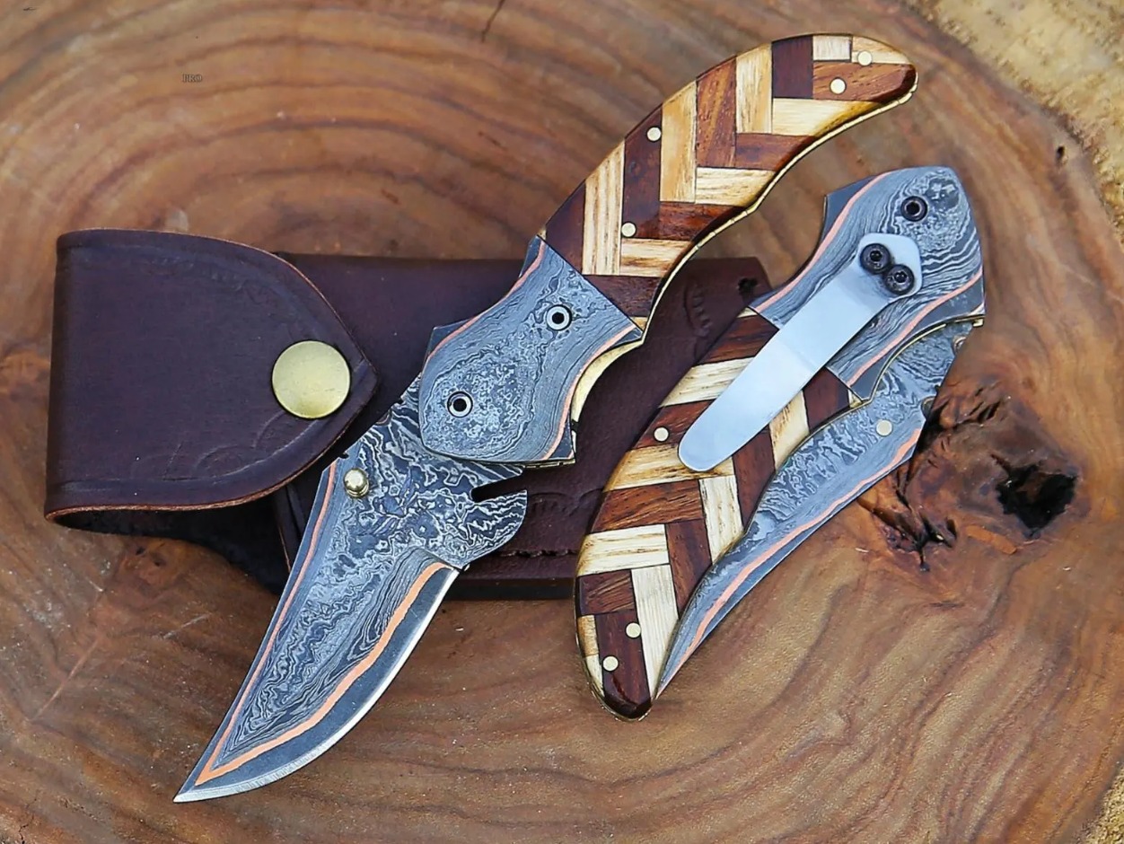 WhatsApp Image 2026-06-19 at 7.31.39 PM (2) Handmade Damascus Folding Pocket Knife – Herringbone Wood Mosaic Handle with Leather Sheath - Image 1